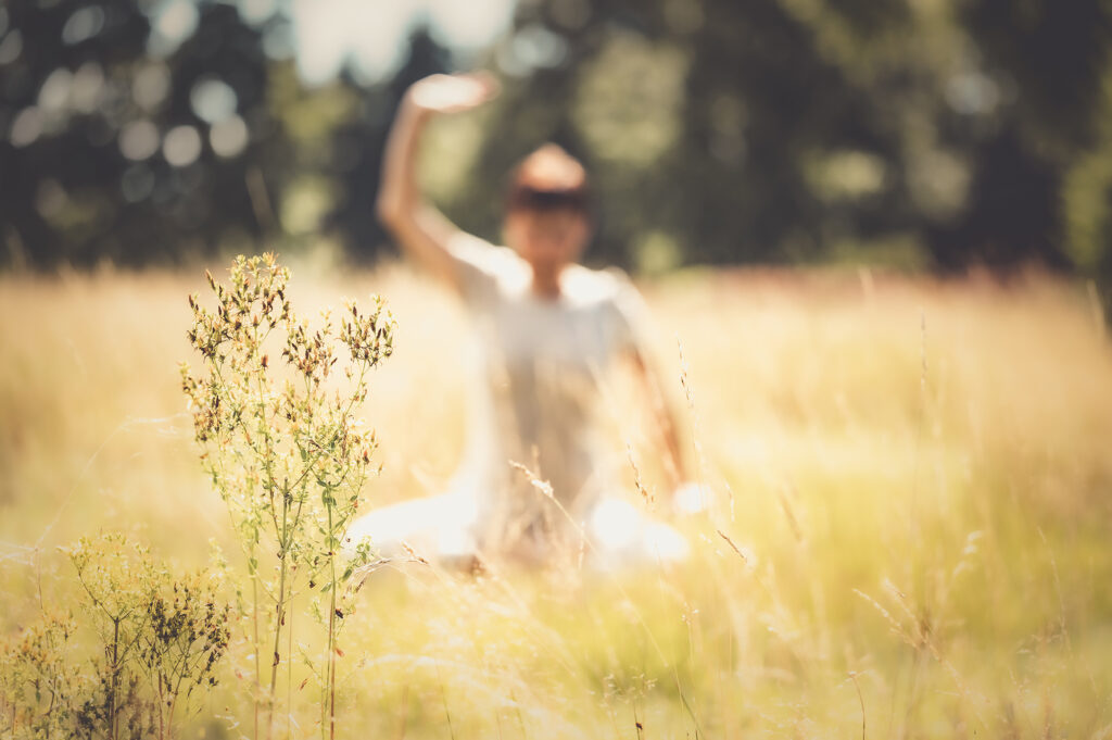 Unscharfes Bild. Ute Gleissner übt Qigong im Kornfeld